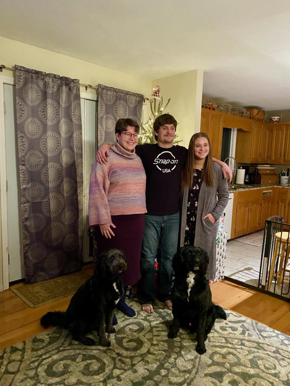 Family with 2 black dogs